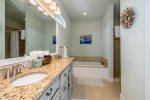 The master bathroom has a separate tub and walk in tile shower 
